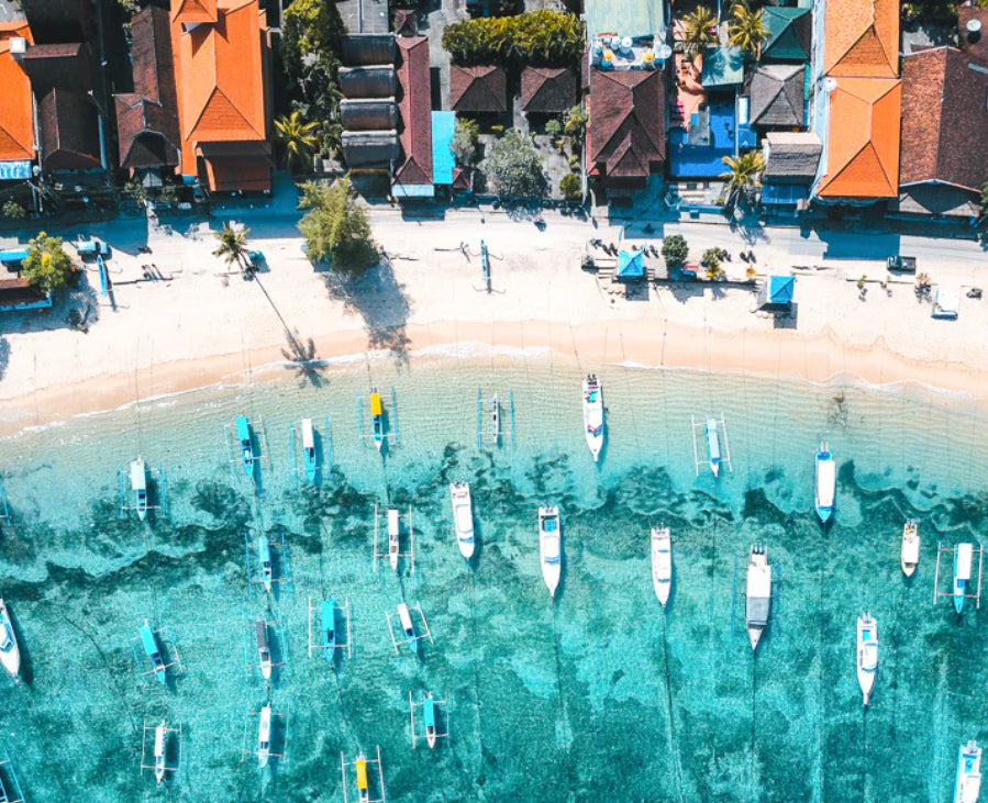Rwenzori swim shorts about this print of Bali Indonesia showcasing fishing boats and blue ocean water and beach used for Bali Boats.