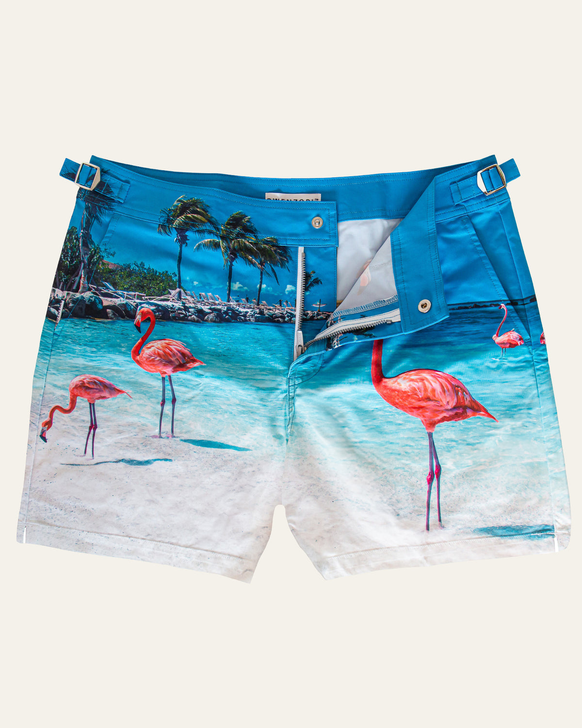Flat lay front view of RWENZORI Flamingos photo print swim shorts on a clean background.
