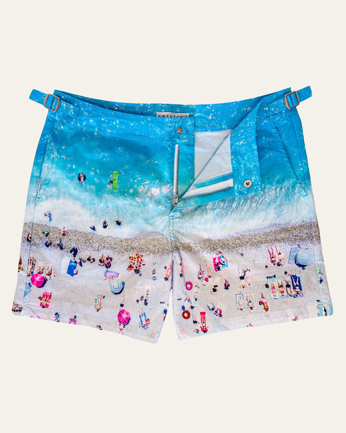 Flat lay front view of RWENZORI French Riviera photo print swim shorts on a clean background.
