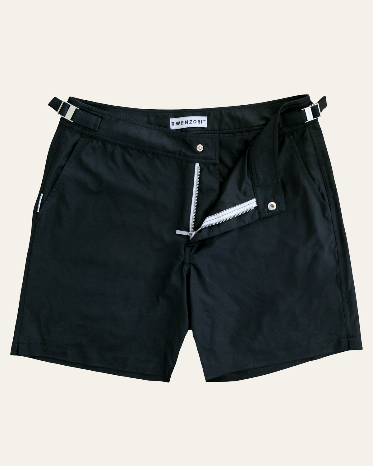 Flat lay front view of RWENZORI Jet Black Performance Series swim shorts on a clean background.