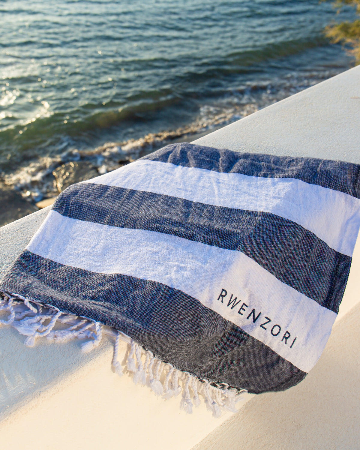 Rwenzori Turkish Towel - Mediterranean Blue in lightweight Turkish cotton, perfect for the beach.