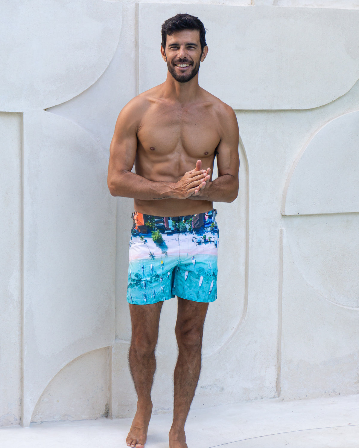 RWENZORI Bali photo print swim shorts — full-frame front view poolside at villa.