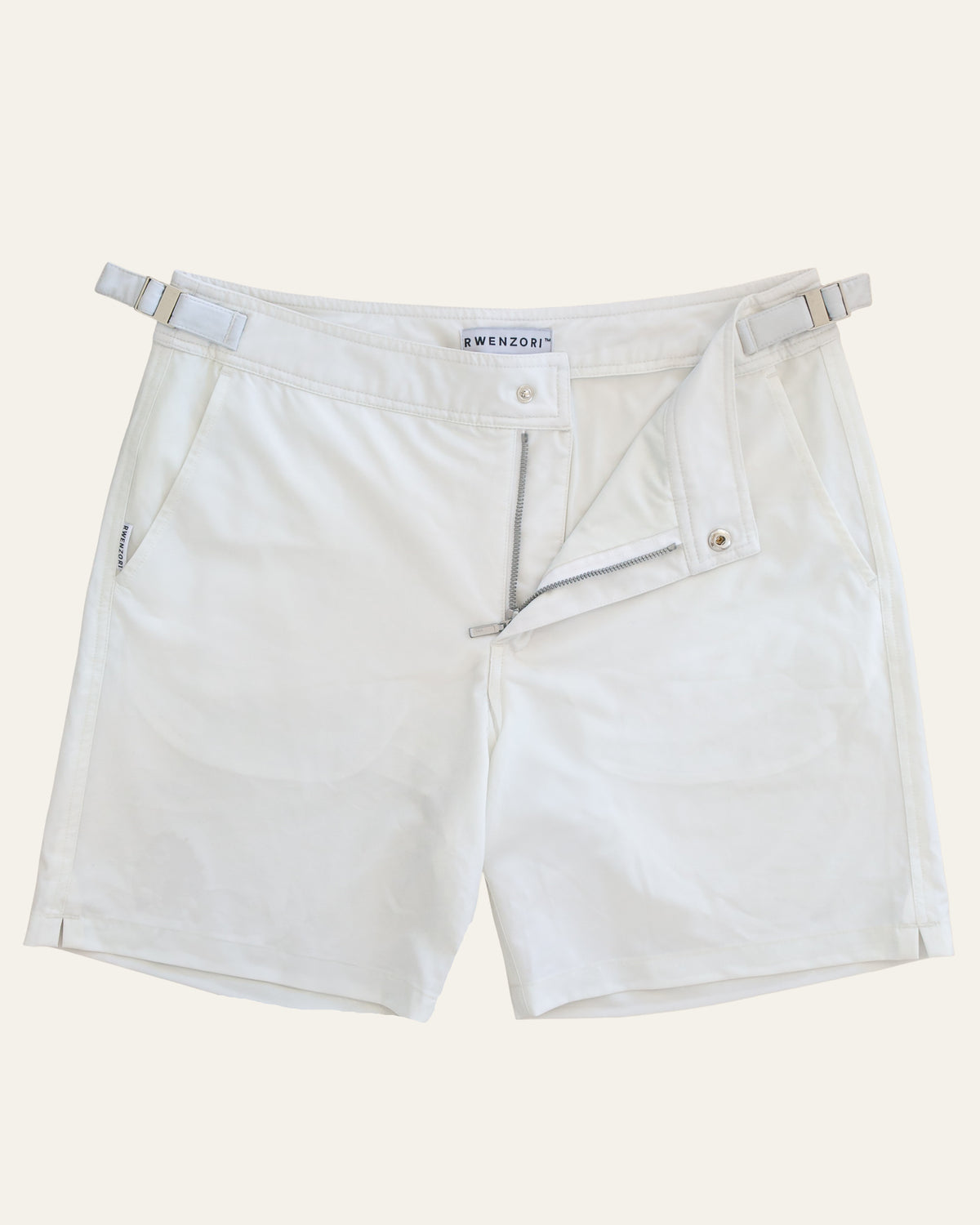 Flat lay front view of RWENZORI Riviera White Performance Series swim shorts on a clean background.