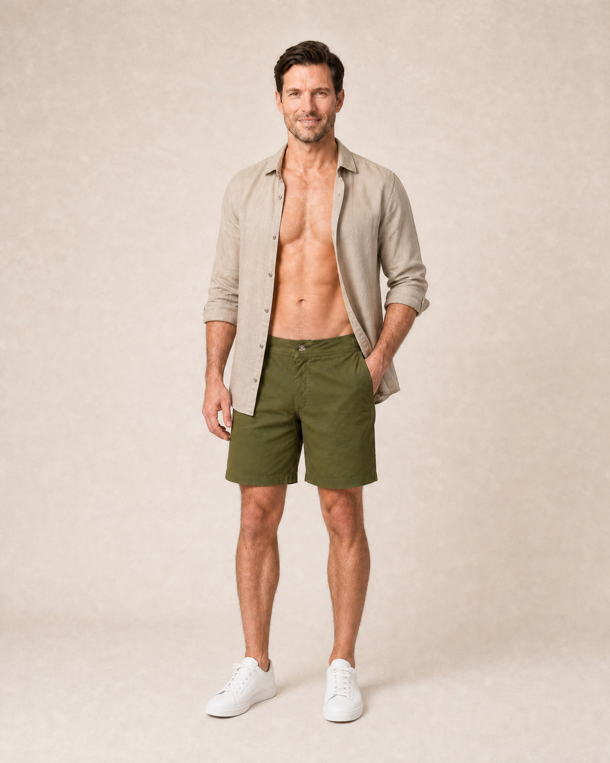 Man wearing RWENZORI Tuscan Olive Performance Series swim shorts with an open linen taupe resort shirt.
