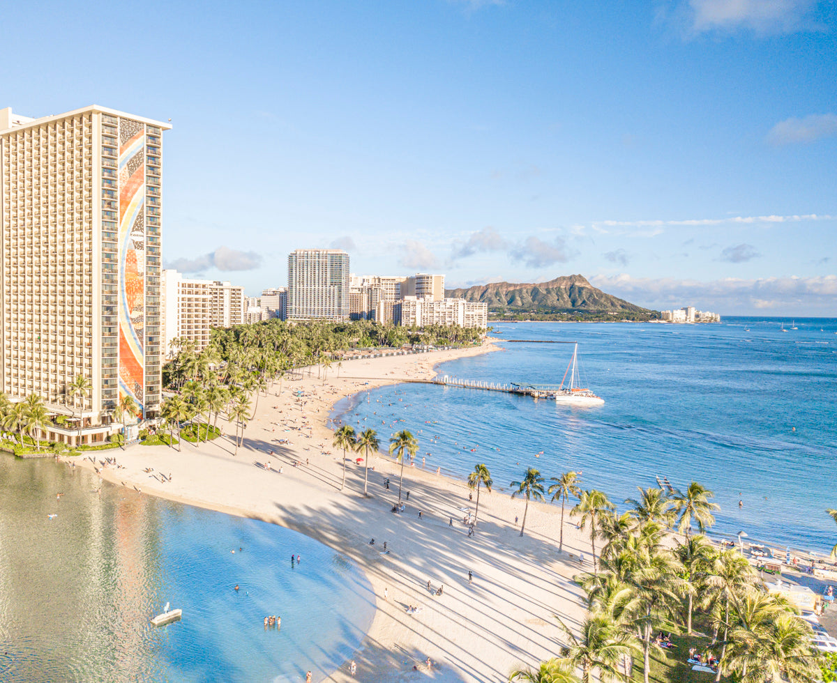 Photo of Waikiki Hawaii used for Rwenzori's mens Waikiki swim trunks showcasing diamond head, beach and surfers.