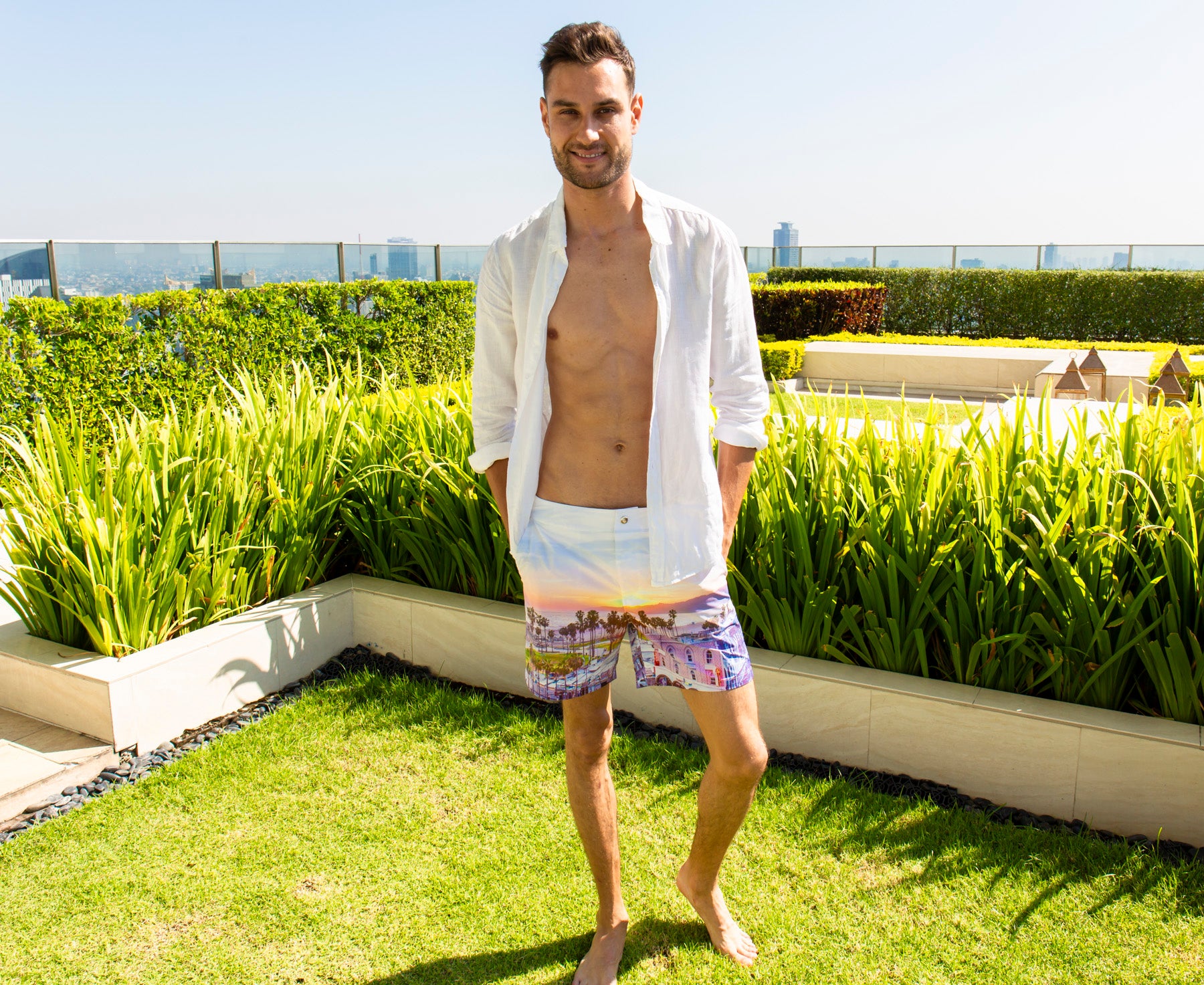 Model wearing Rwenzori Venice Beach swim shorts on rooftop garden